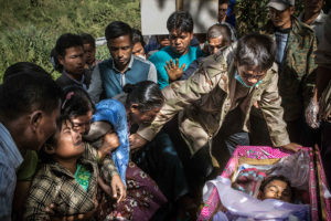 [SeriesTitle: The Price Of Jade] The funeral of 24-year-old Ko San Tin, a freelance jade miner who died being run over by a jade mining company dump truck, Hpakant, Kachin State, Myanmar, November 28, 2015. The next day, angry locals blocked the village road stopping the company trucks to pass through. The company quickly made an agreement with Ko San Tin's family for a compensation and closed the case. Ko San Tin who has just been in Hpakant for five months, left a 2-year-old, a wife and parents who he was supporting for.