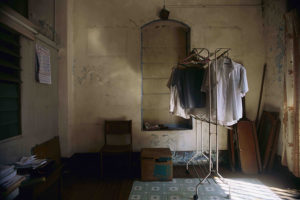 Still-life-with-ghost-posters,-hanging-shirts,-and-one-packed-box-rush8261#13A_MAster